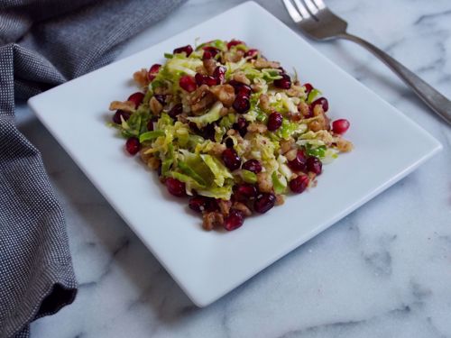 Picture of Brussels Sprouts Salad with Crispy Walnuts, Pomegranate and Parmigiano